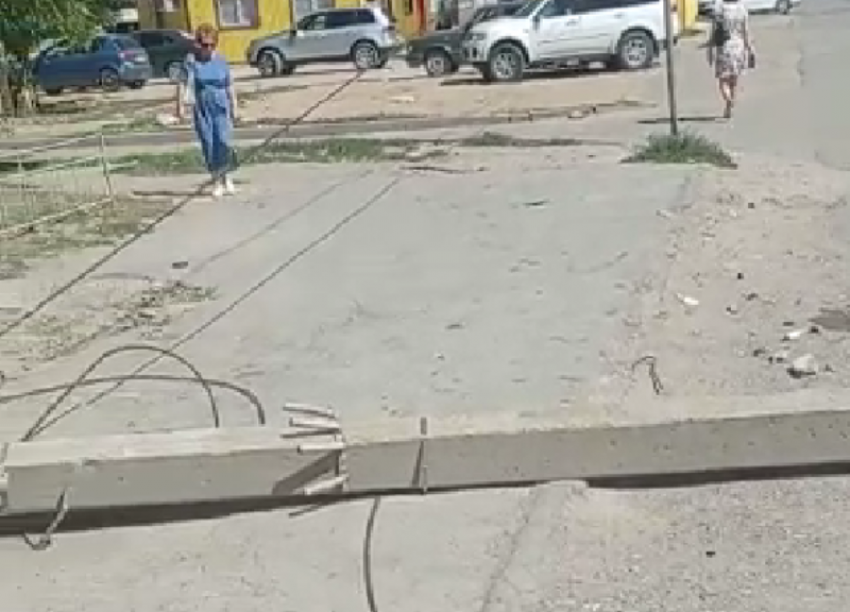 Поваленный на дорогу бетонный столб с проводами не убирают после непогоды под Волжским 